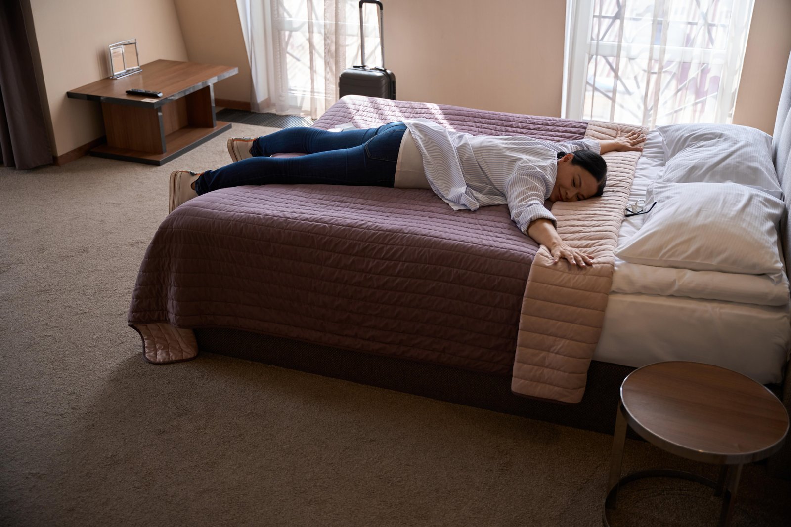 tired-traveler-is-resting-in-her-hotel-room-upon-a-2025-03-07-09-05-34-utc